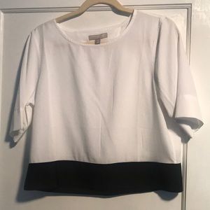 Adorable silky top with cut out detail in back.